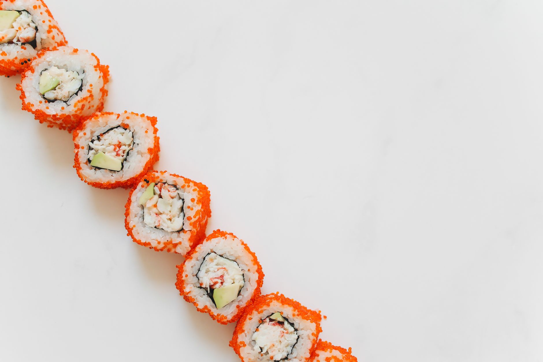 Varieties of tobiko on sushi rolls showcasing different colors