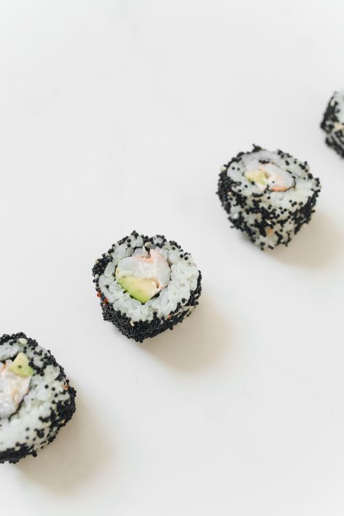 Free Delicious sushi rolls with black sesame seeds on a white background. Perfect for Japanese cuisine lovers. Stock Photo