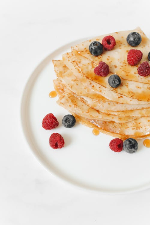 Free Homemade Crepes with Berries on White Plate Stock Photo