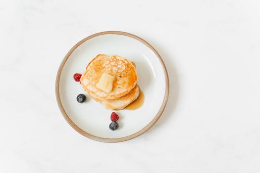 Pancakes With Red and Black Berries on White Ceramic Plate