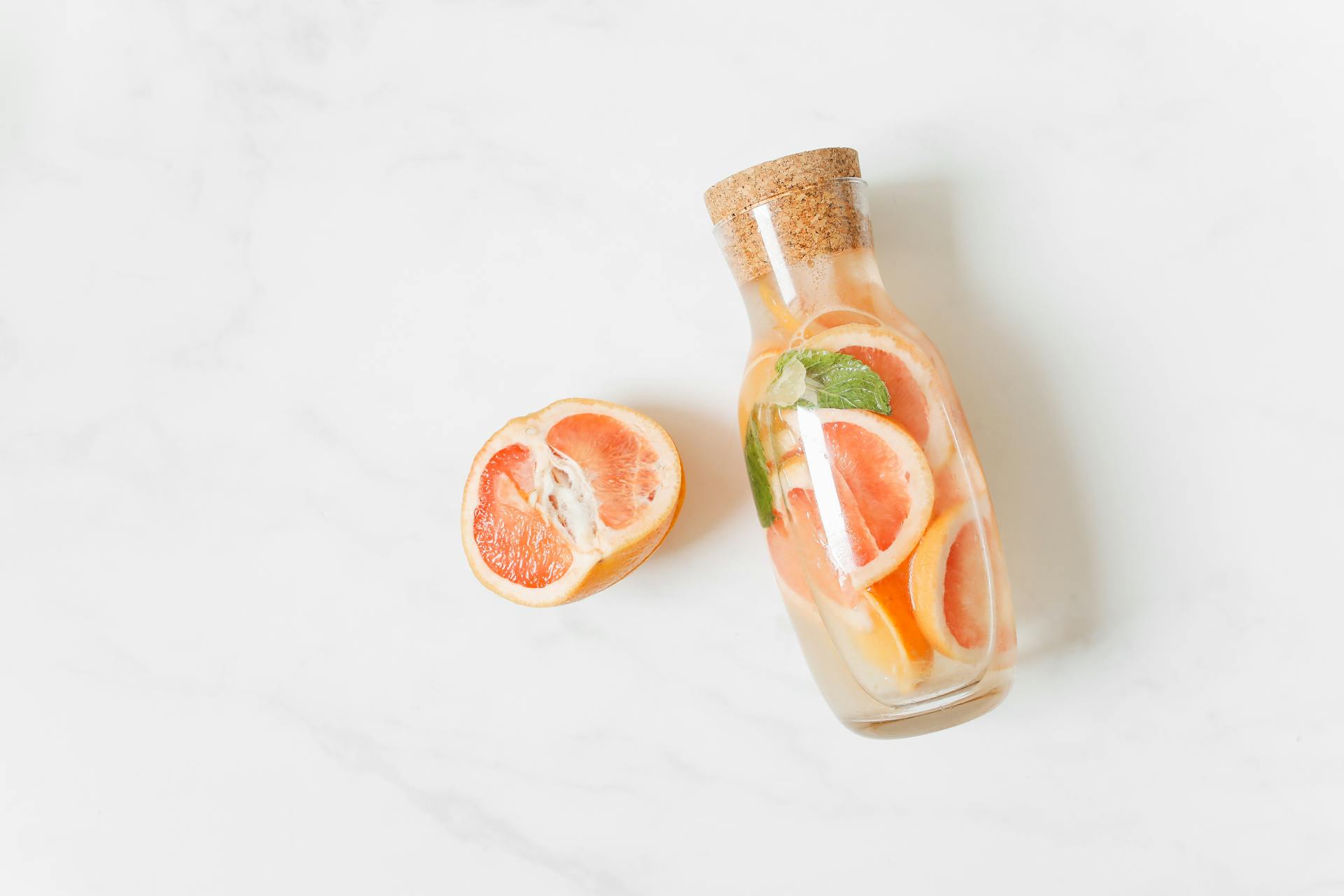 Sliced Orange Fruit Beside a Healthy Refreshing Beverage