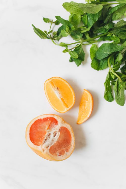 Free Flat lay of vibrant lemon, grapefruit, and mint on a marble background. Stock Photo