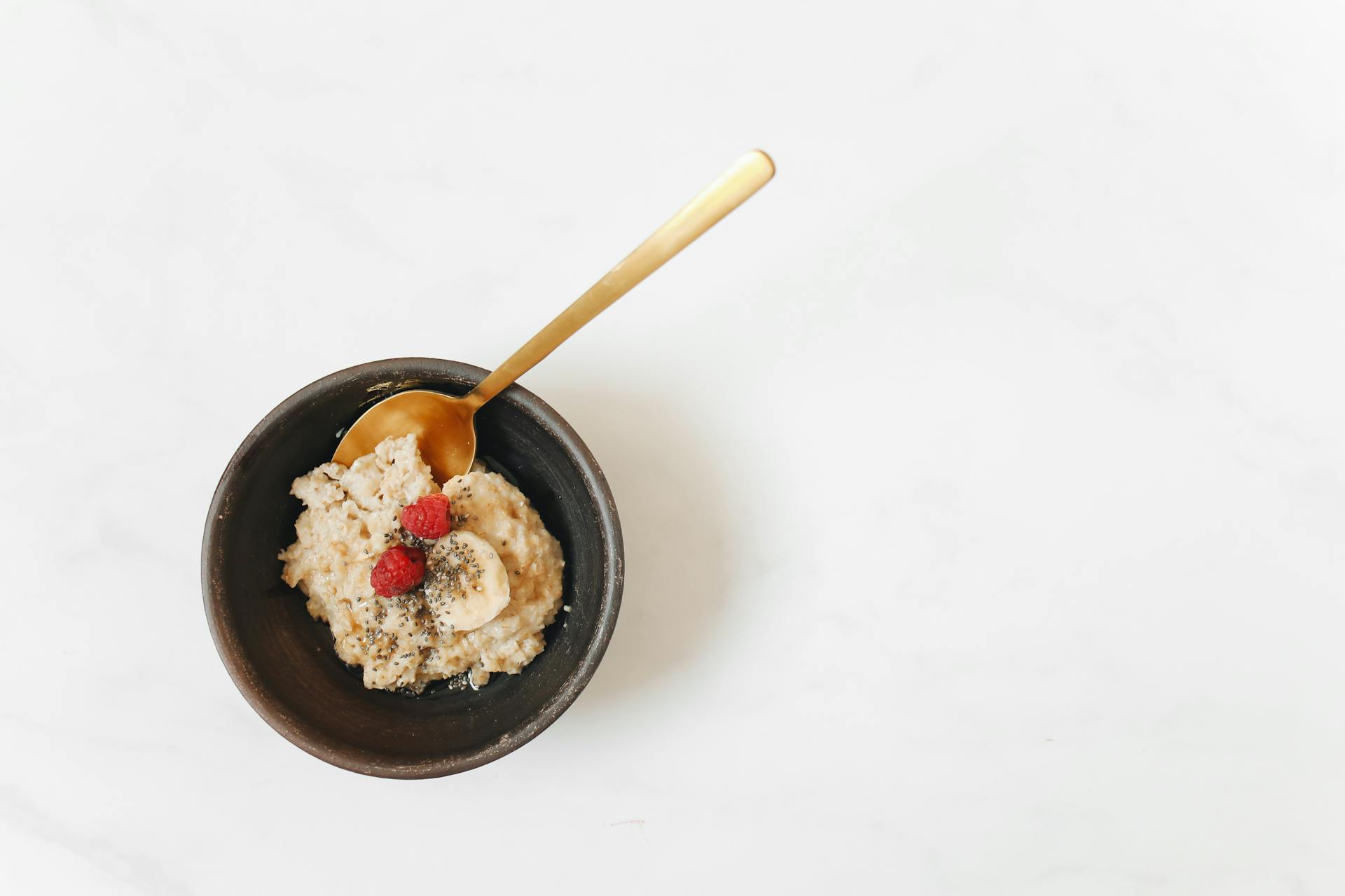 Oatmeal with Fresh Fruits in a Bowl with Spoon