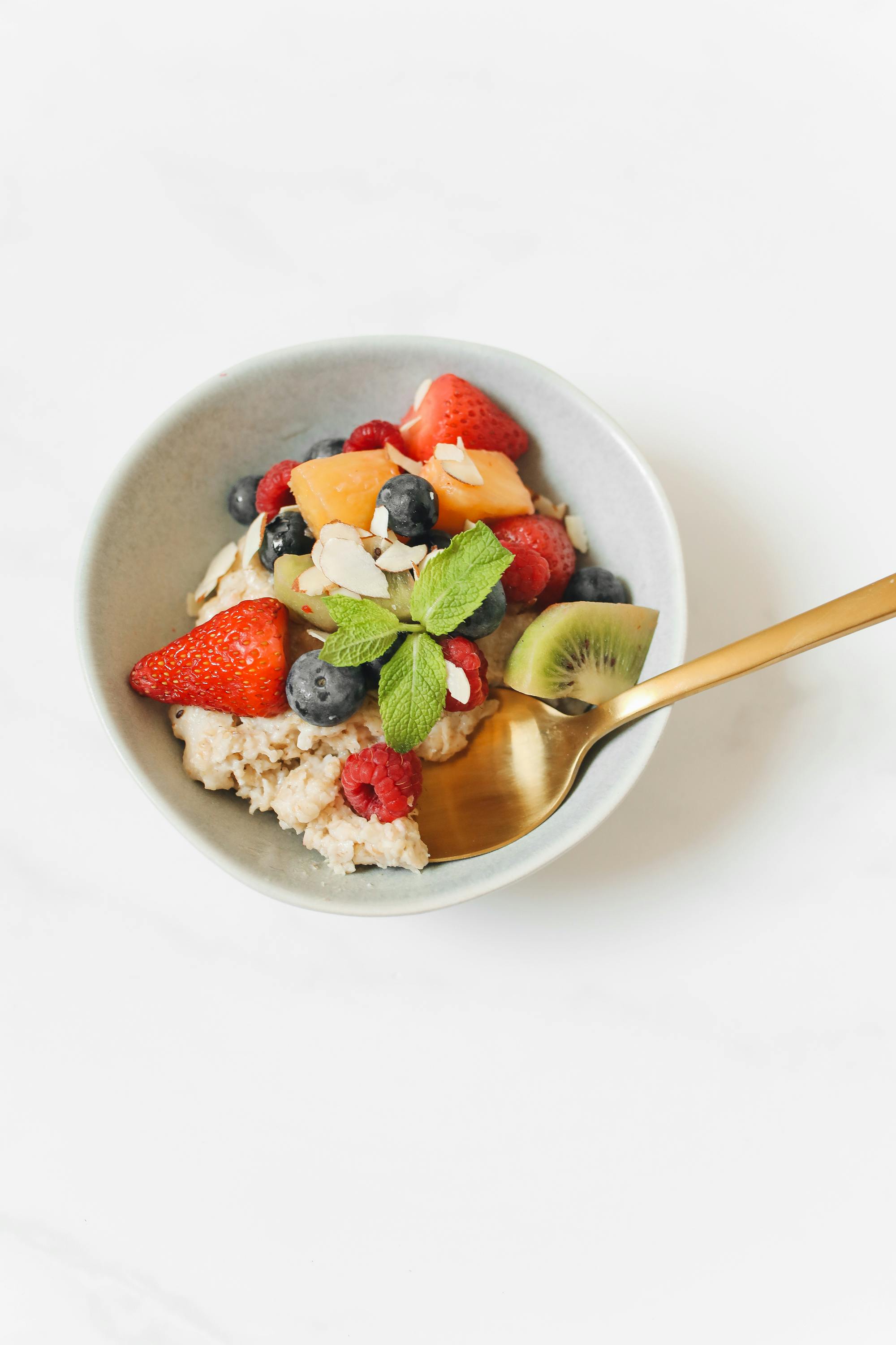 oatmeal with sliced fresh fruits in a ceramic bowl