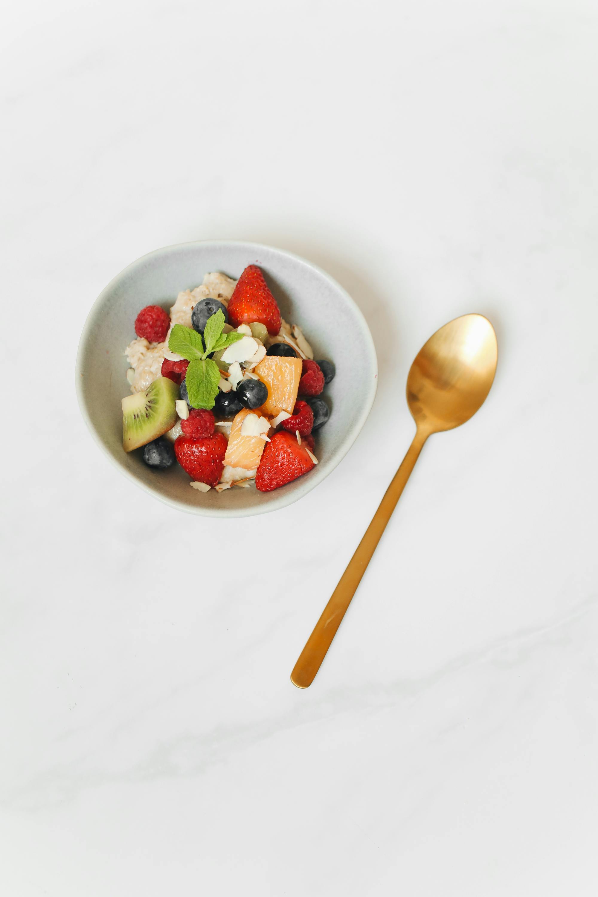 a gold spoon beside a breakfast bowl