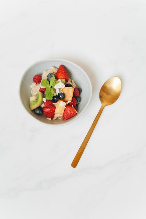 Free A Gold Spoon Beside a Breakfast Bowl Stock Photo