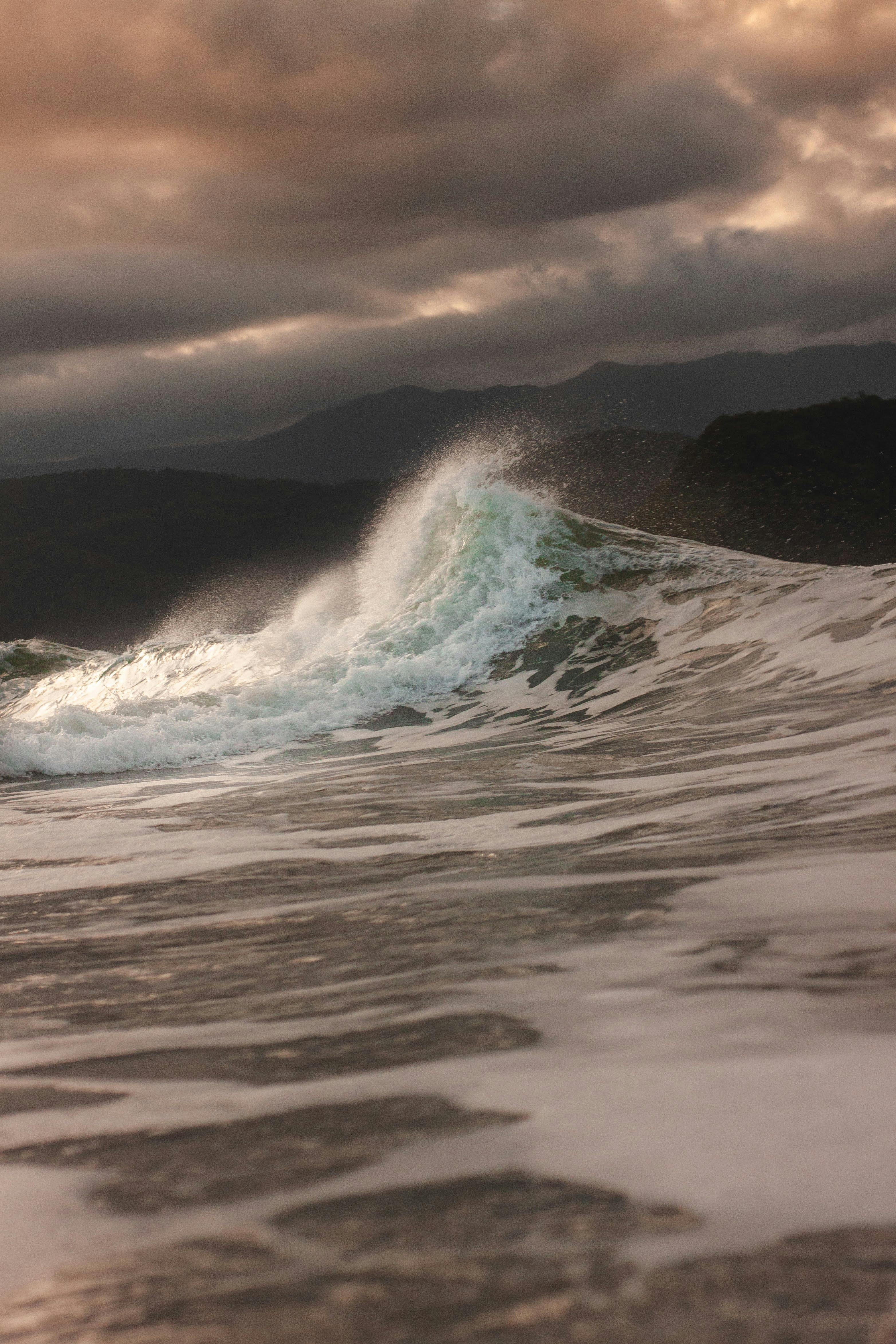 sea wave crushing under dramatic sky