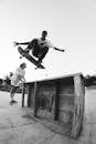 Young active skater leaping high in park