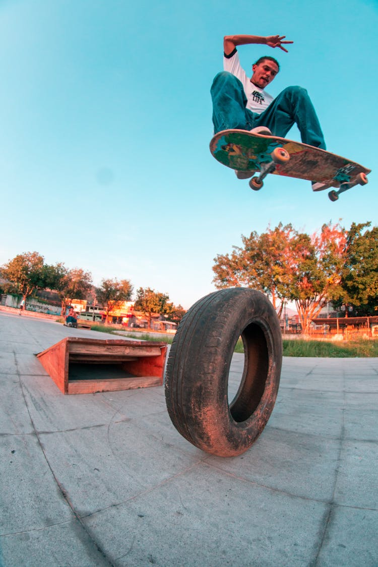 Young Ethnic Man Jumping On Skateboard