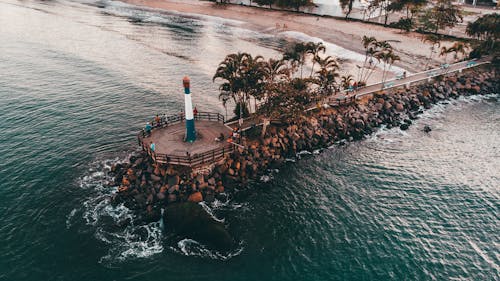 Drone view of modern lighthouse on tropical seashore