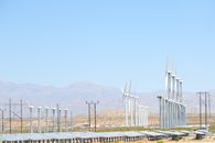 Clear sky over wind turbines next to simple constructions