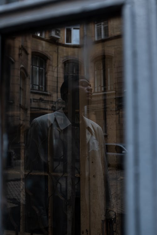 Man in White Dress Shirt Standing Near Window