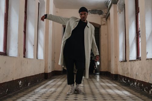 Free A stylish male model in a vintage hallway, showcasing urban fashion with natural lighting. Stock Photo