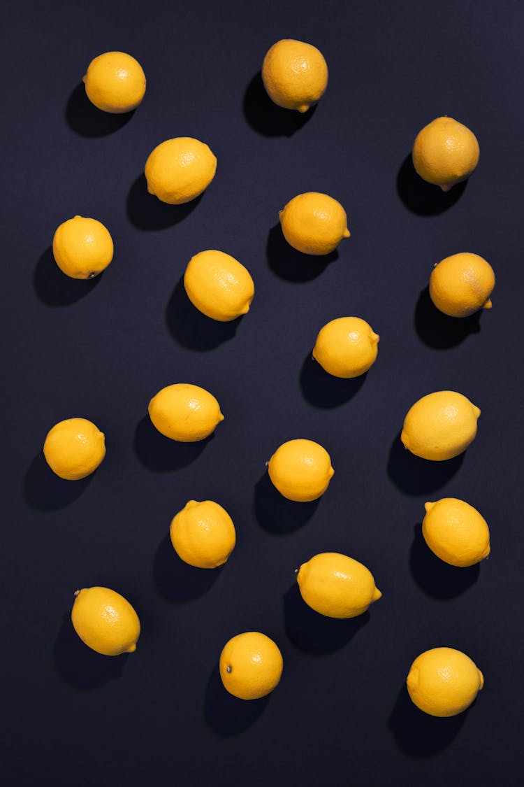 Ripe Lemons On A Black Surface