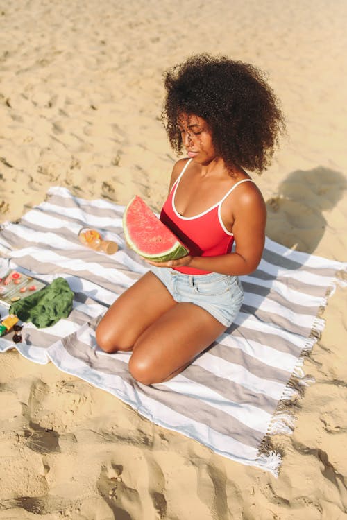 Woman On A Beach Towel Holding A Watermelon
