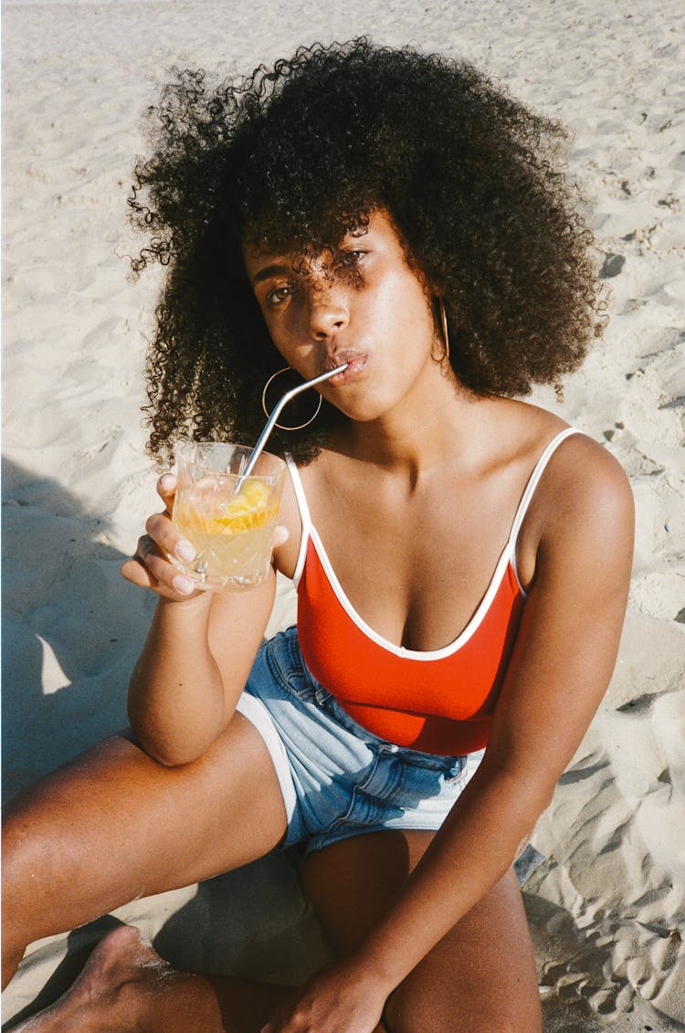 Woman Drinking On Beach