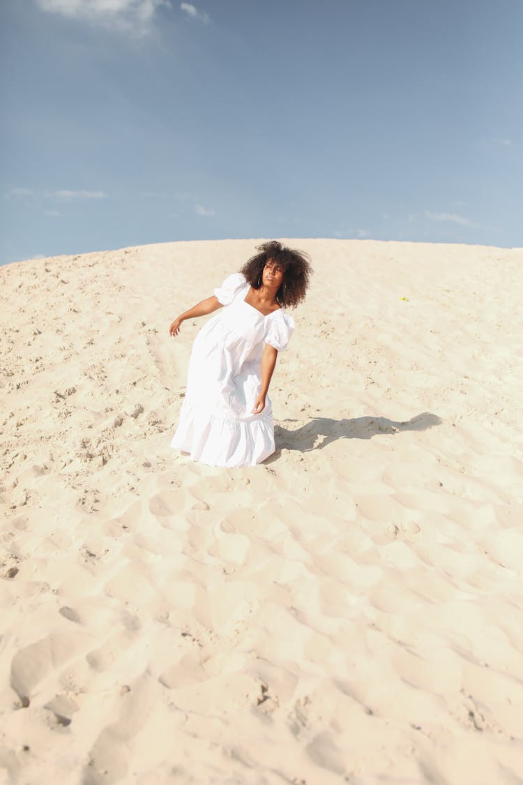 Woman Posing In White Dress Walking On Sand