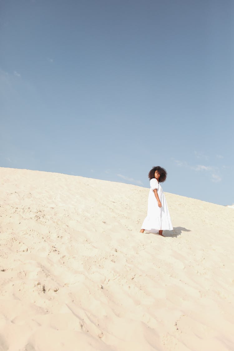 Woman In White Dress Walking On Sand