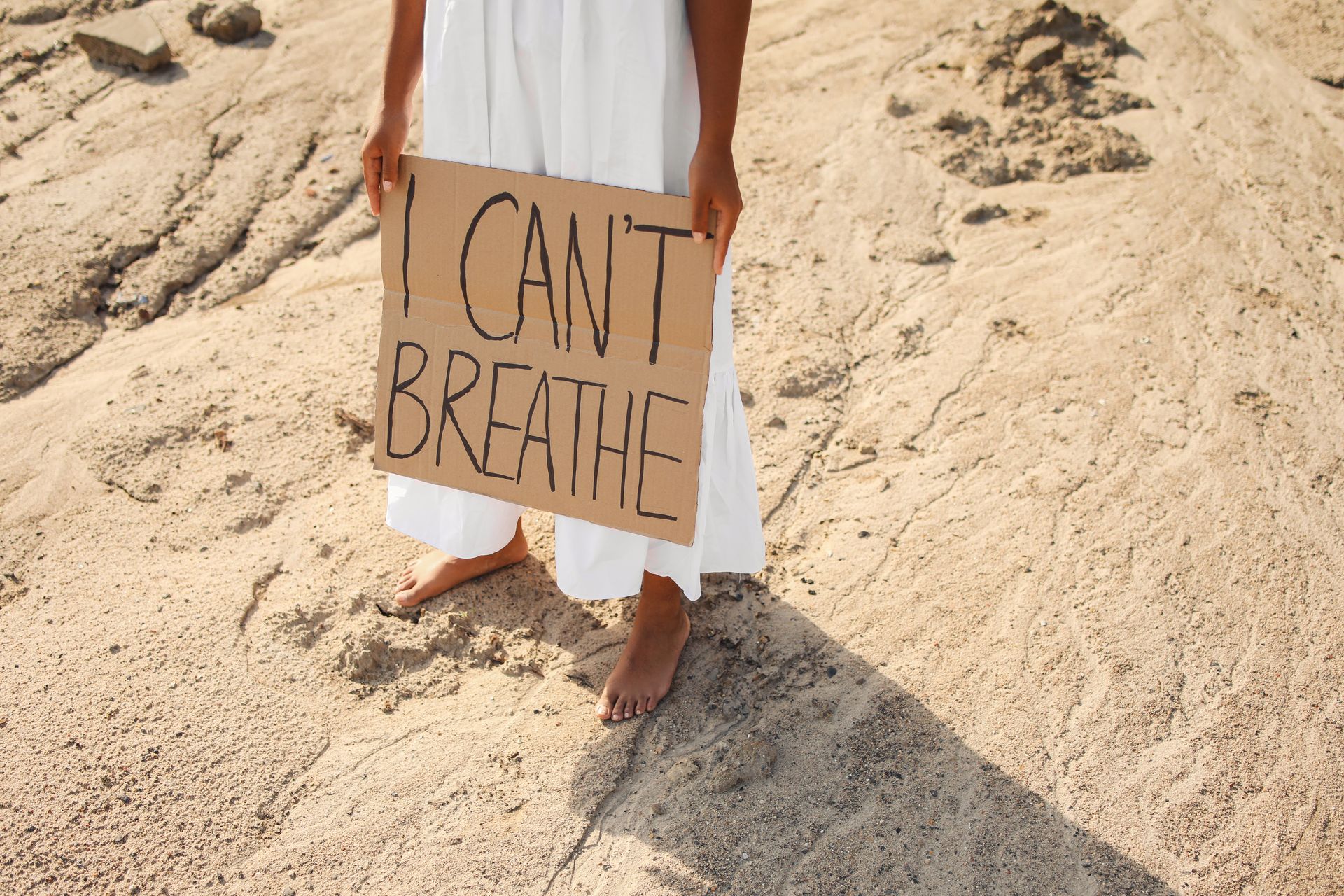 A Person in Long White Skirt Holding a Banner