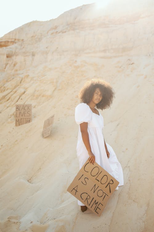 Free Woman in Dress with Transparent on Desert Stock Photo