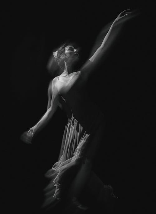 Black and White Blurry Photo of a Woman Dancing 