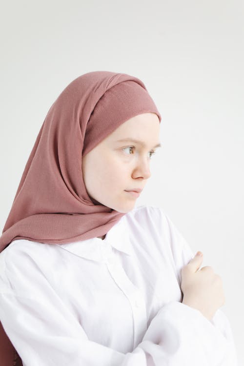 Woman in White Long Sleeve Shirt and Brown Hijab