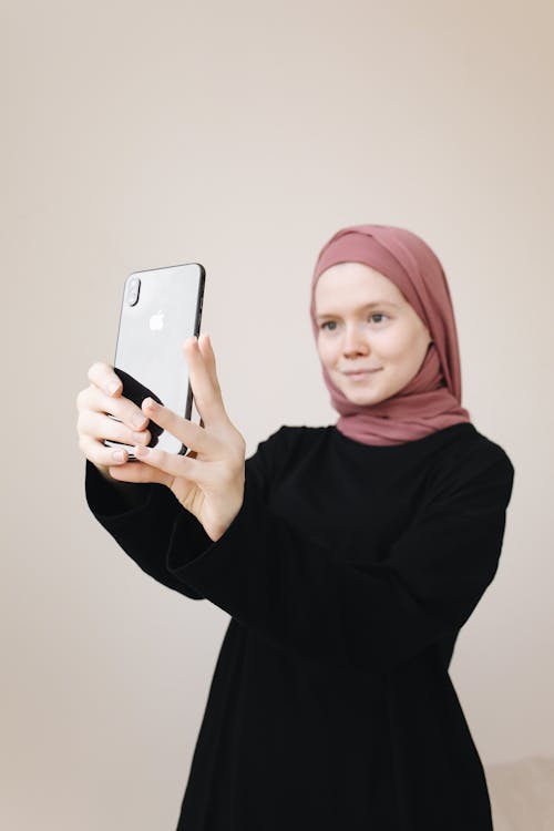 Free A Woman in a Black Dress Taking a Selfie Stock Photo