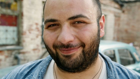 Smiling man with a beard outdoors — photo by Artem Podrez on Pexels