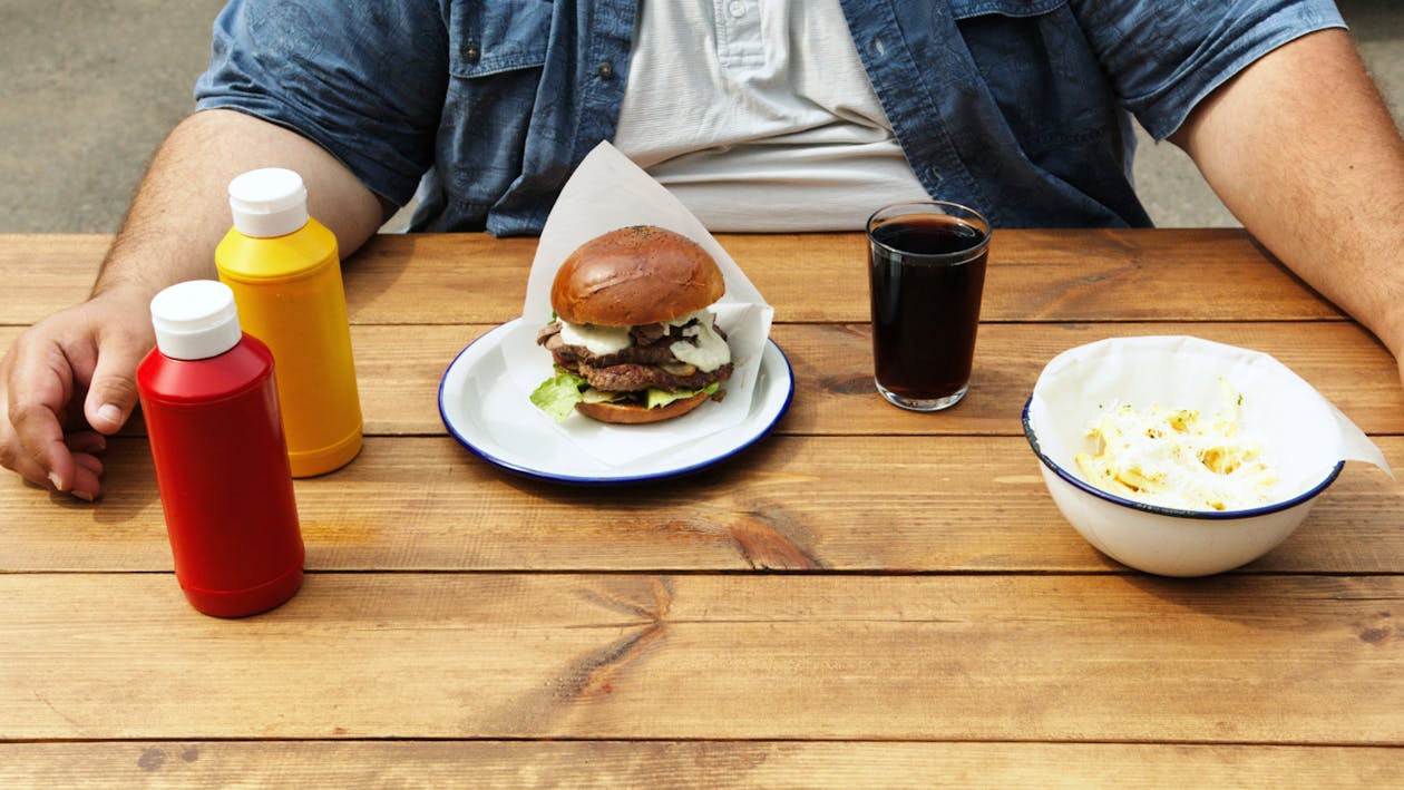 Free Burger on White Ceramic Plate on Wooden Surface  Stock Photo