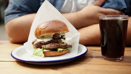 Burger on Pink and White Plate