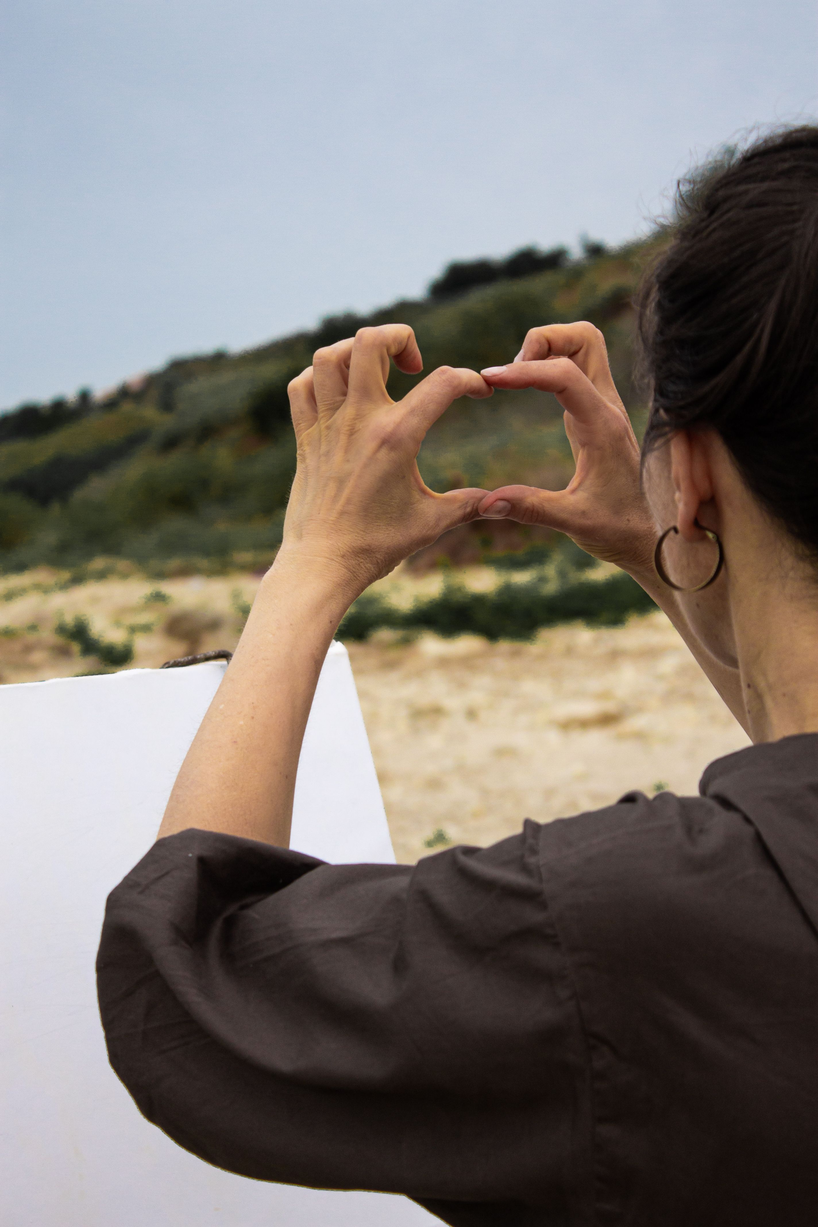 Woman making frame gesture while preparing for painting · Free Stock Photo