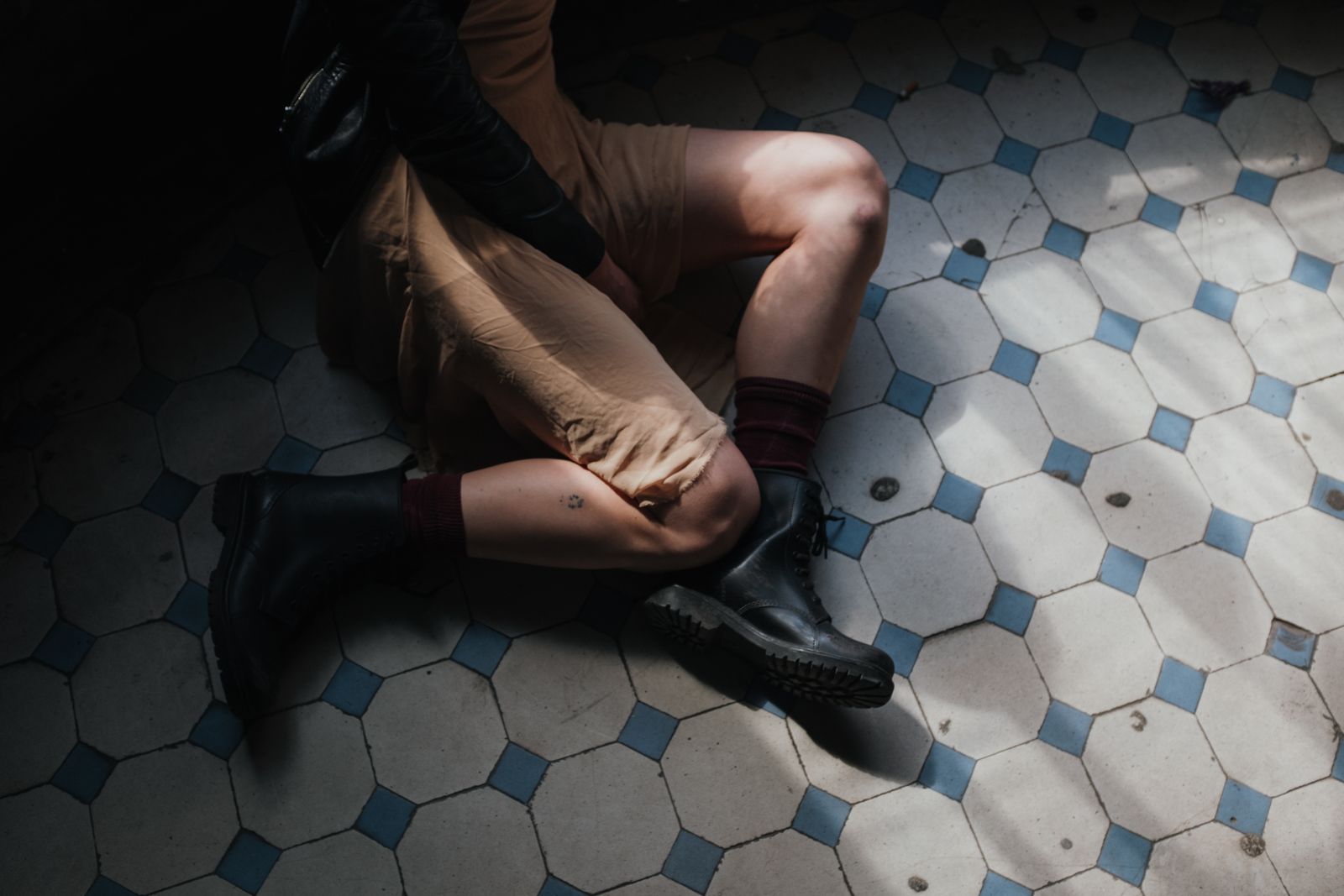 Person adjusting a compression sock before walking outdoors