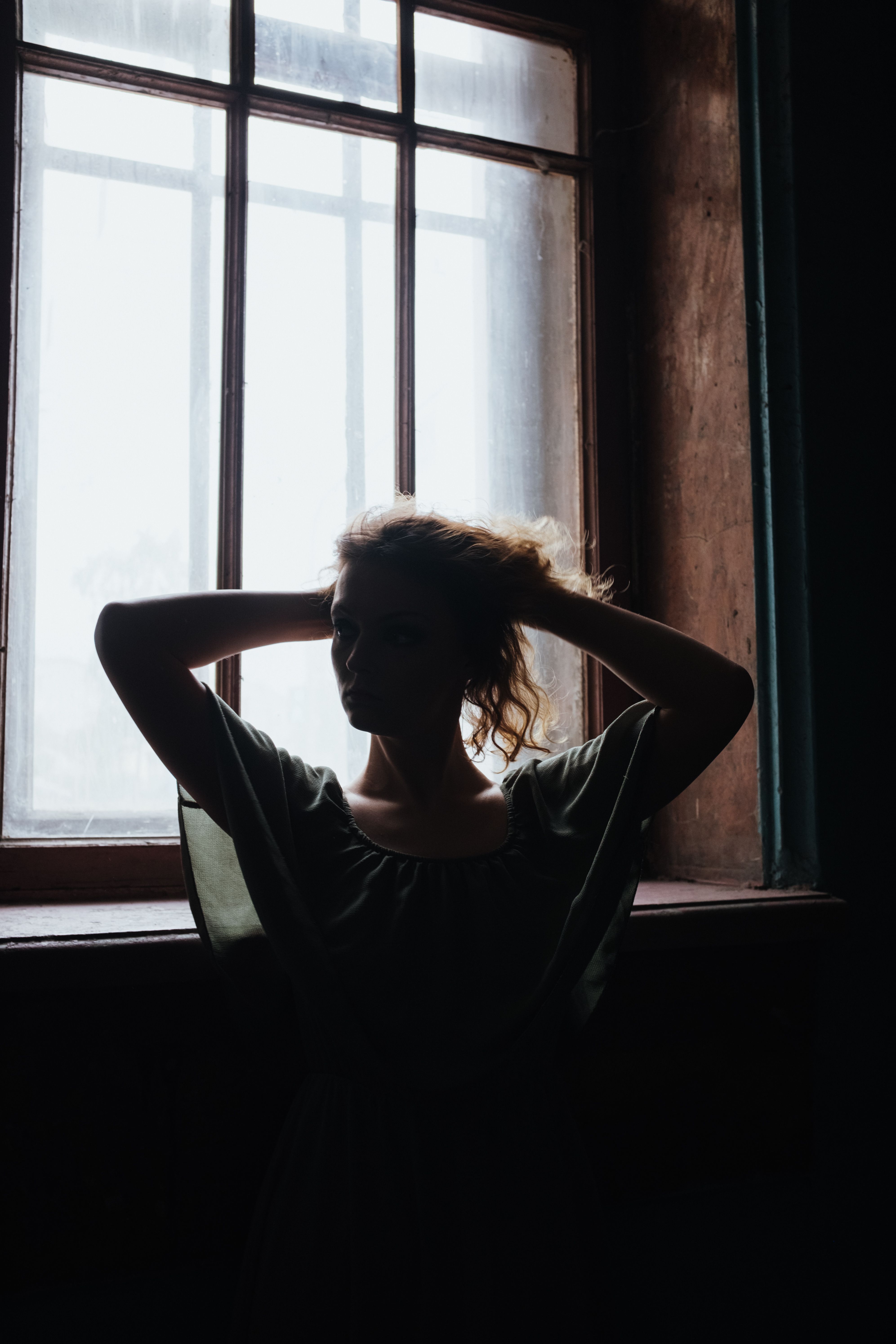 Woman in Black Shirt Looking Out the Window · Free Stock Photo