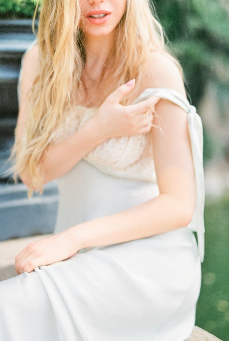 A Woman Holding The Sleeve Of Her Dress