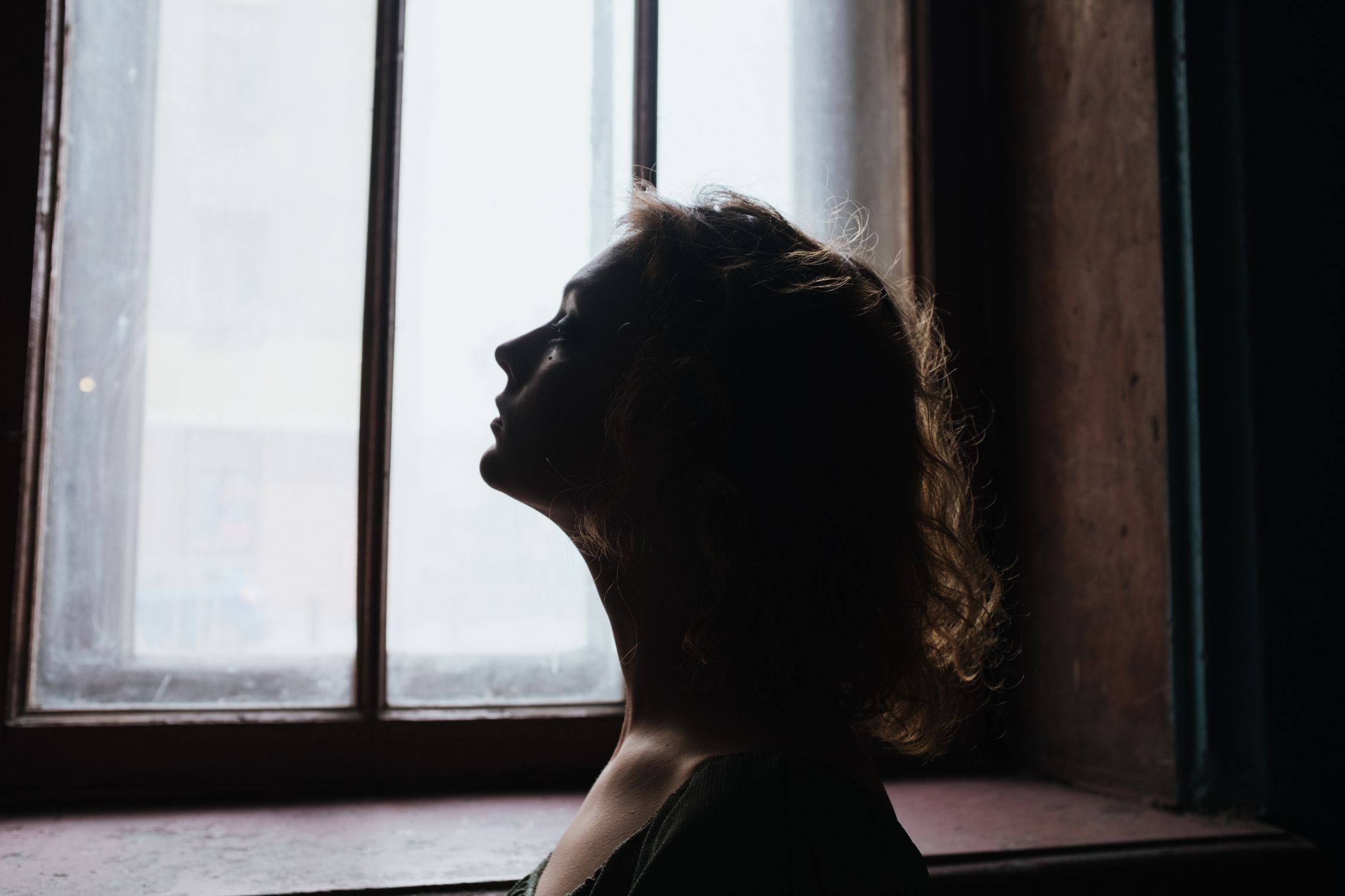 Woman in Black Shirt Looking Out the Window · Free Stock Photo