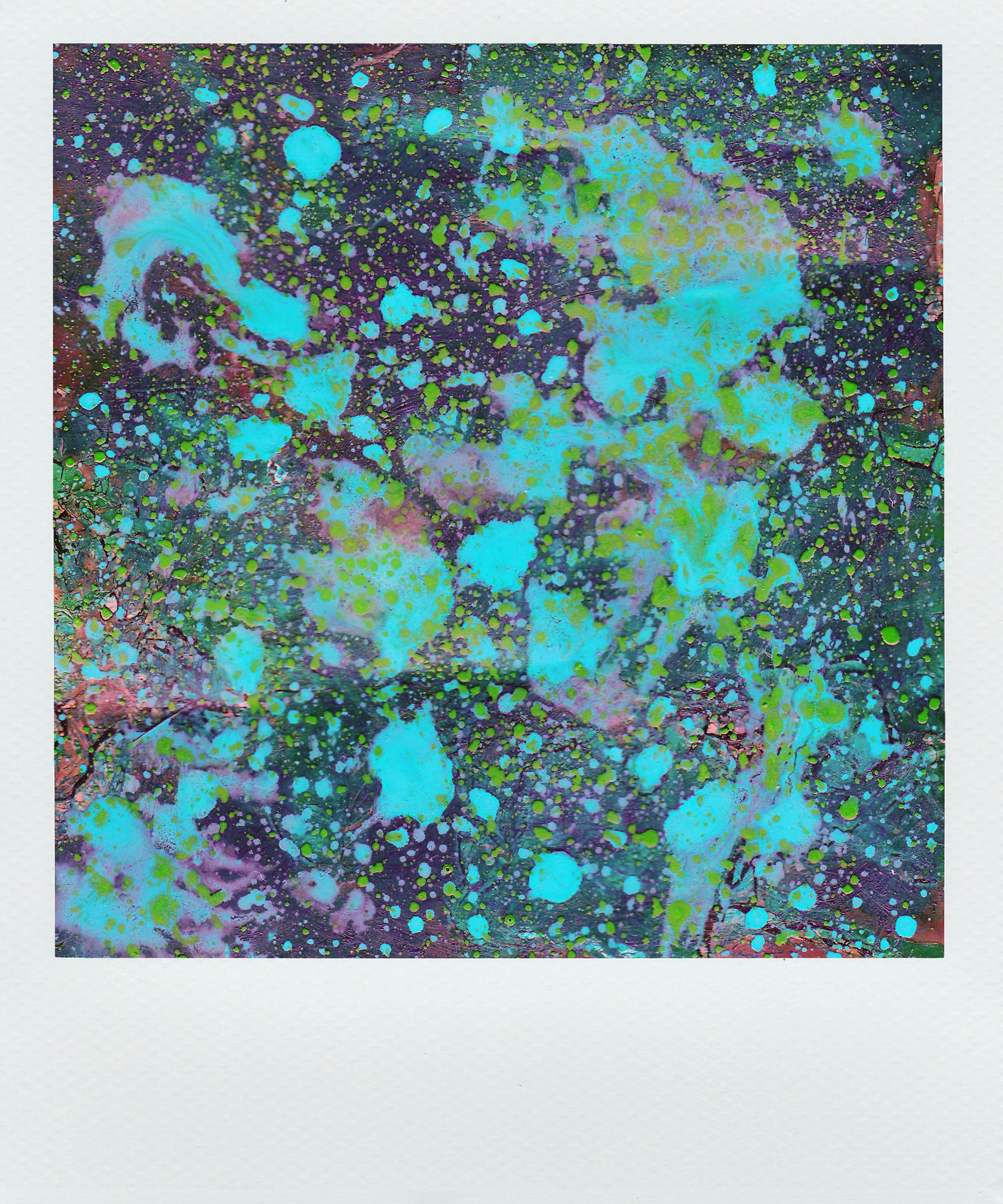 Vivid abstract artwork with colorful paint splatters creating a dynamic texture.