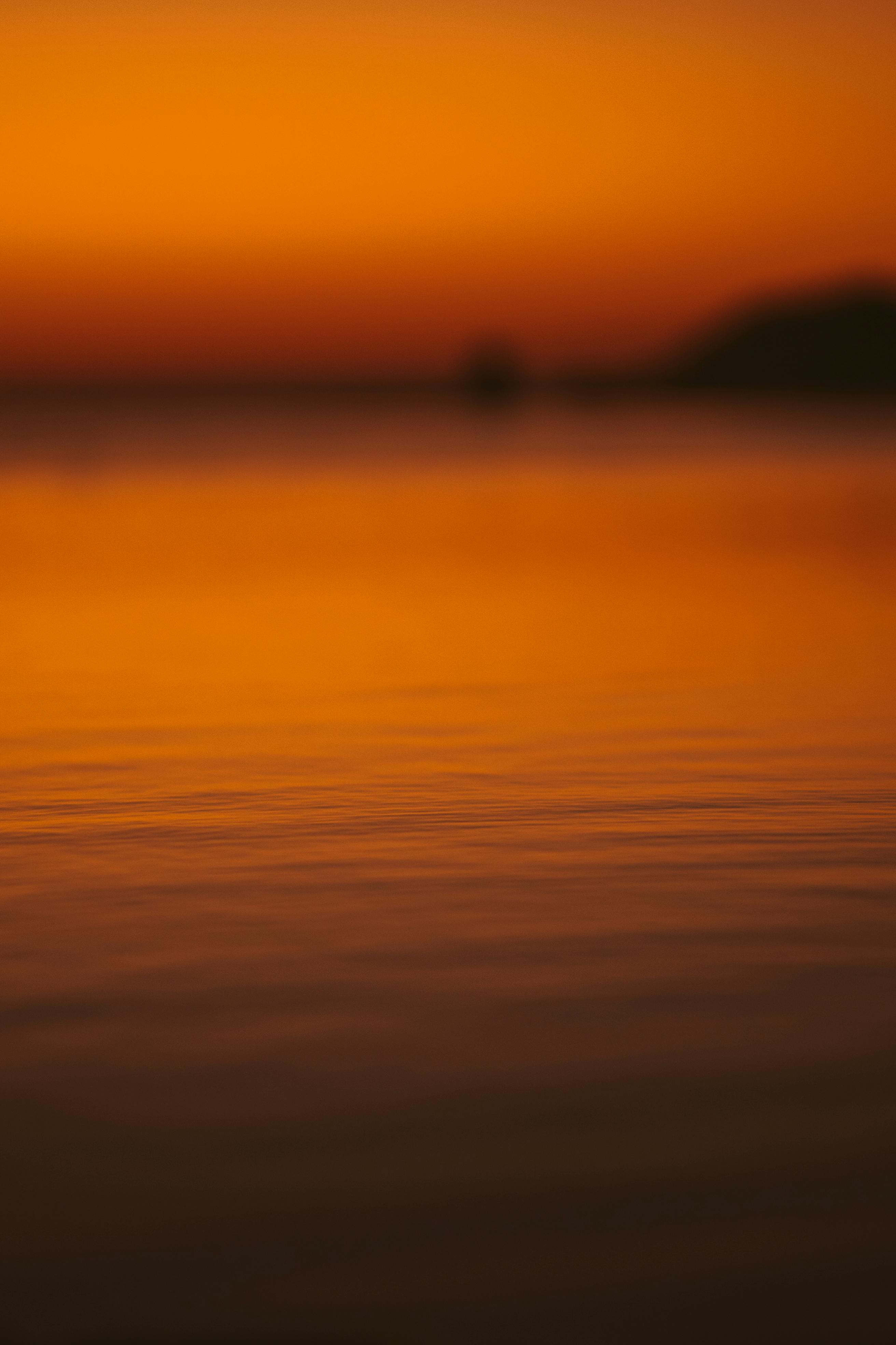 a close up shot of a body of water during sunset