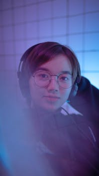 Portrait of a young woman wearing eyeglasses and headphones in a vibrant, modern setting.