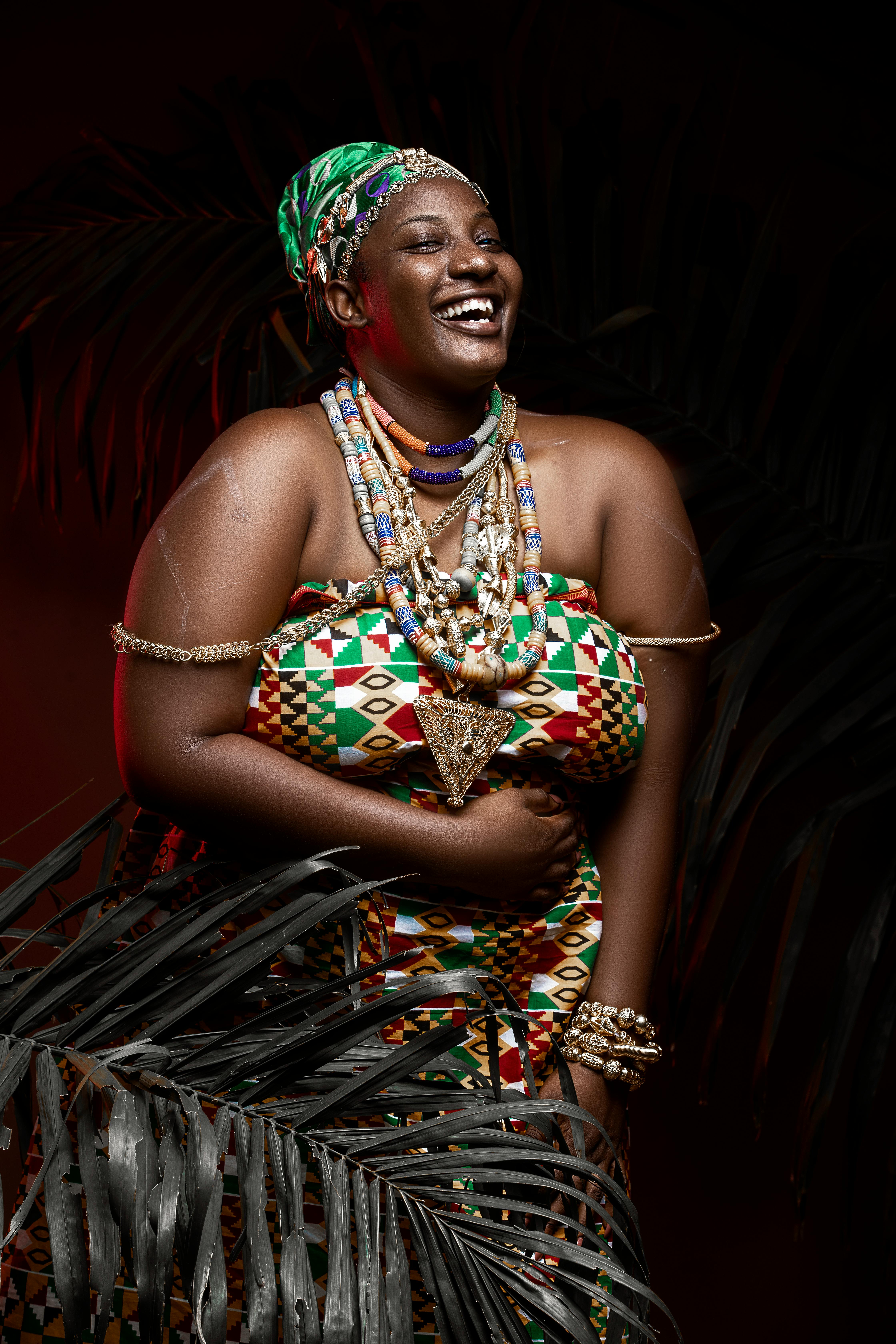 smiling black woman in traditional outfit and accessories