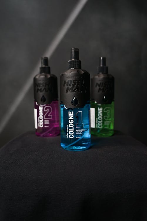 Free After Shave Colognes in Different Variants on a Black Surface Stock Photo