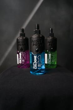 Three stylish cologne bottles displayed artistically on a dark backdrop, perfect for product advertising.