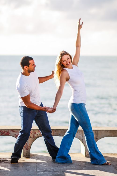 Free A cheerful couple dancing by the sea in Olinda, Brazil, capturing love and happiness. Stock Photo