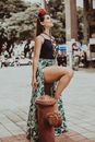 Trendy smiling woman in modern apparel on street pavement