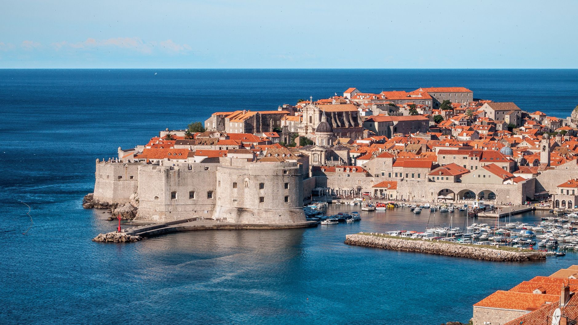 A stunning aerial shot of Dubrovnik's old town and harbor, showcasing historical architecture.