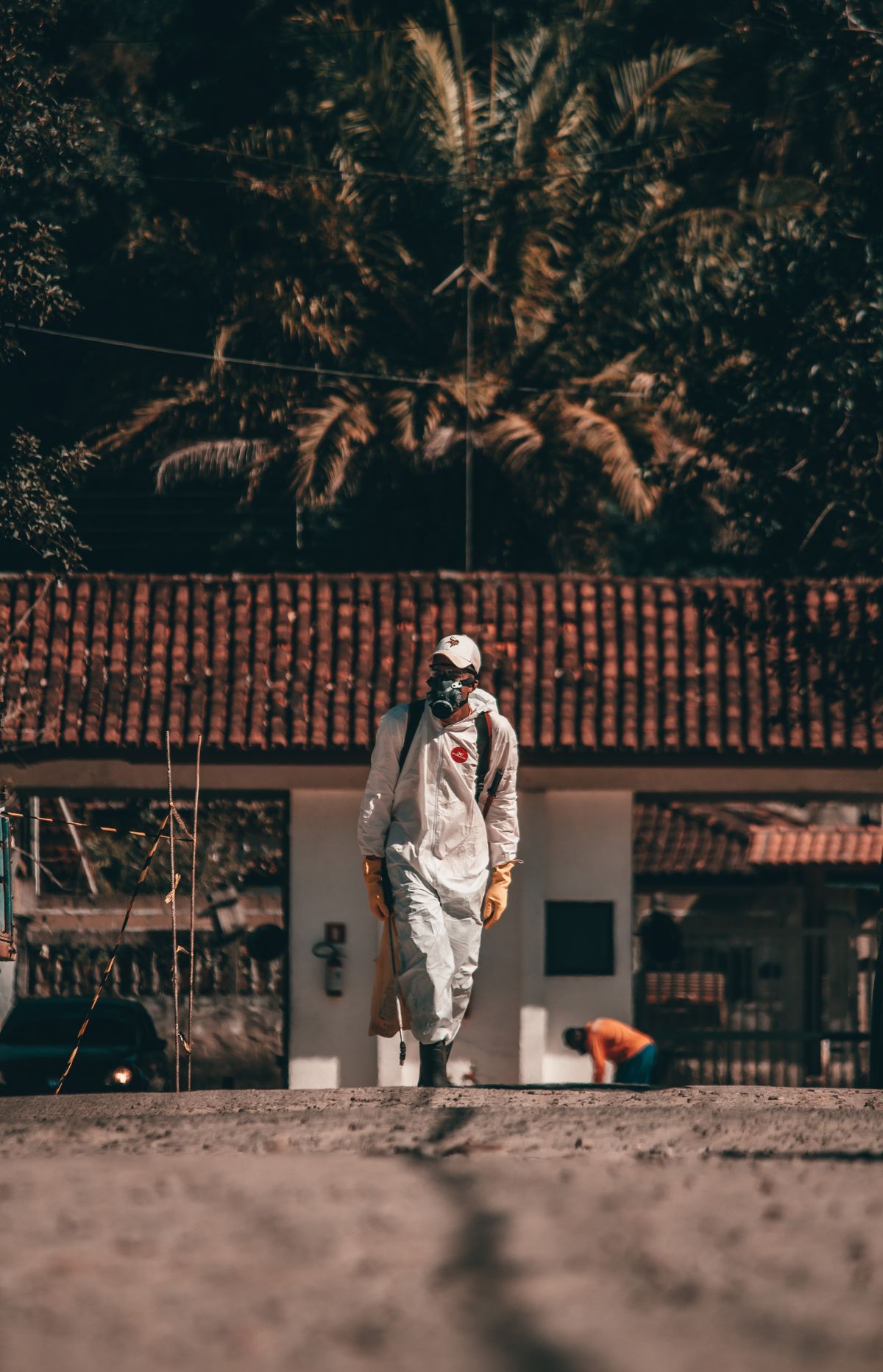 Spray technician in full protective suit and respirator on site
