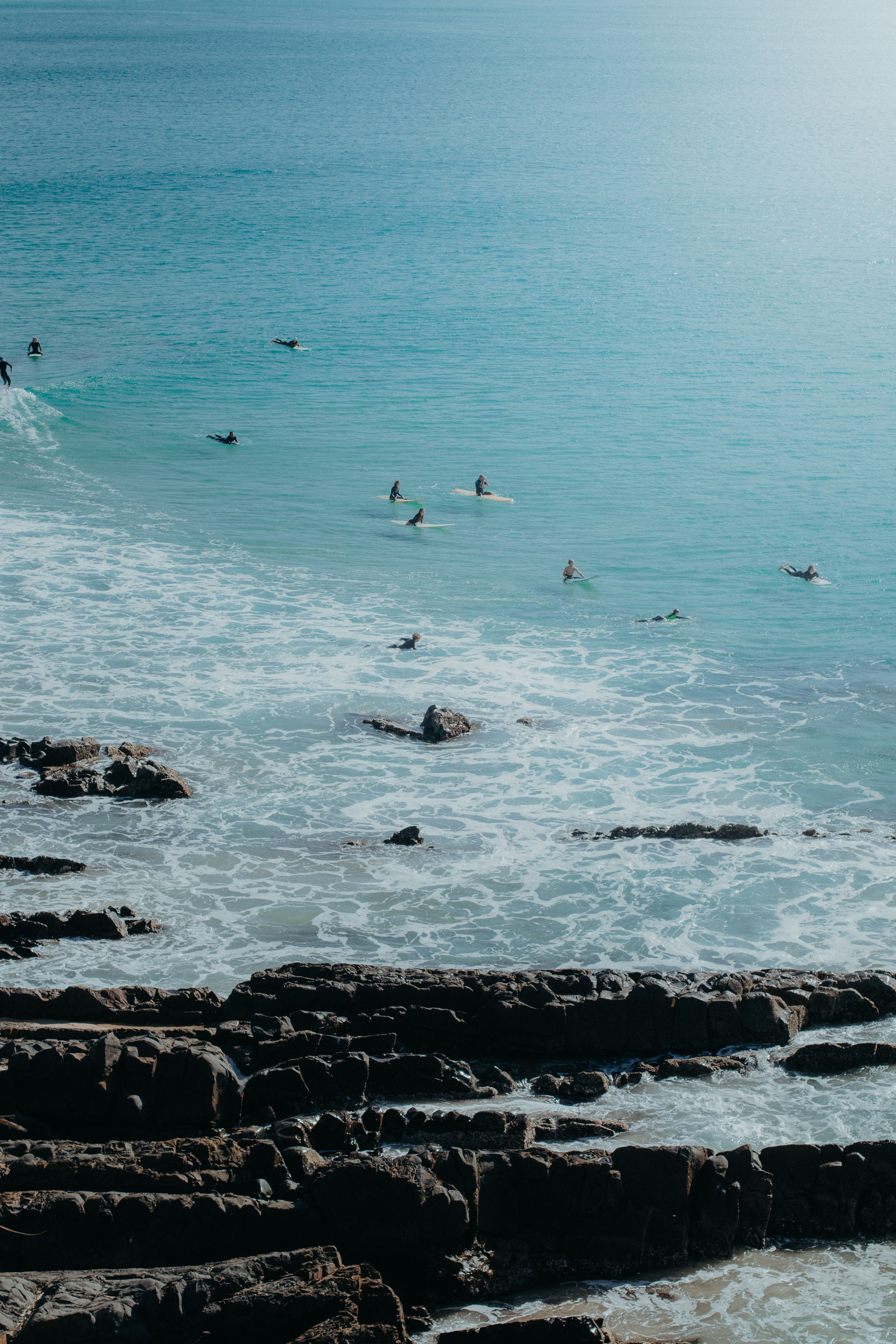 A stunning aerial view of surfers enjoying the waves at Crescent Head Beach in New South Wales, Australia.