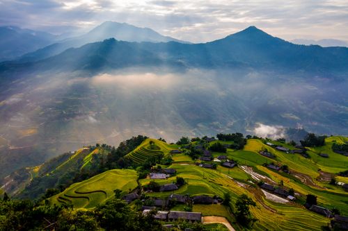 Free A breathtaking view of rice terraces in Hà Giang, Vietnam, under the sunlit sky. Stock Photo