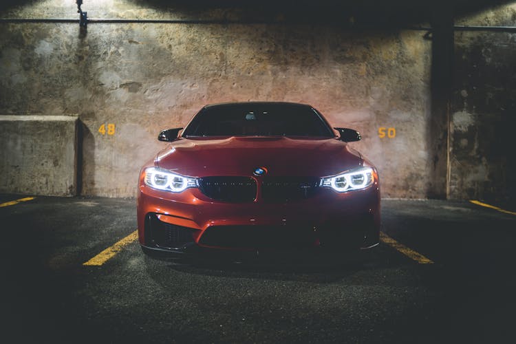 Red Car In Garage Under Flashlight