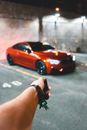 Crop person unlocking car in garage
