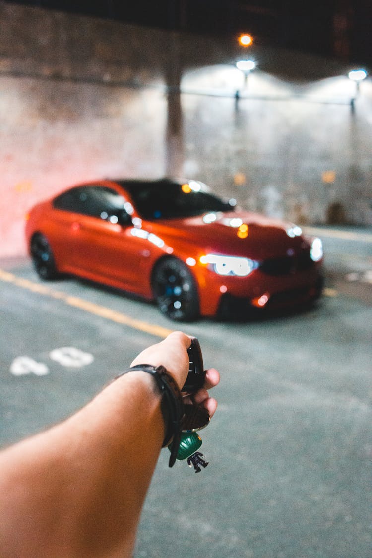 Crop Person Unlocking Car In Garage